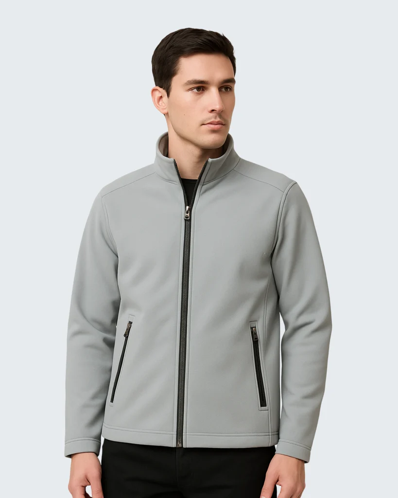 flat lay of a light gray softshell jacket on a clean white background. sleeves extended zippers visible minimal shadows top down view high clarity no logo. 5 819x1024