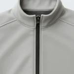 flat lay of a light gray softshell jacket on a clean white background. sleeves extended zippers visible minimal shadows top down view high clarity no logo. 6 768x960