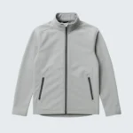 flat lay of a light gray softshell jacket on a clean white background. sleeves extended zippers visible minimal shadows top down view high clarity no logo. 7 768x960